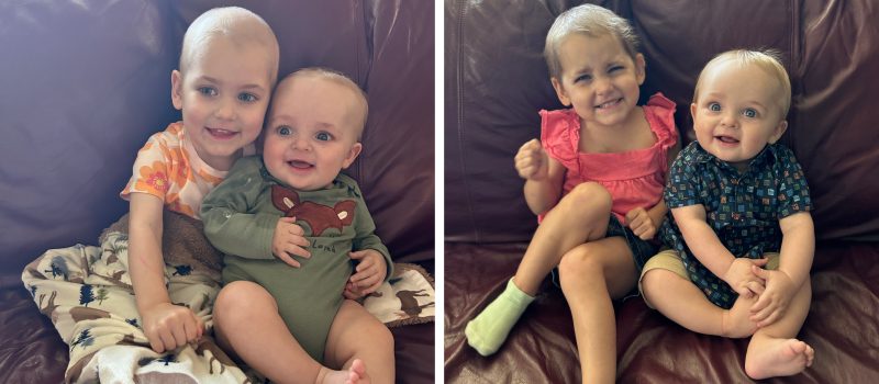 Blakely sitting on a couch holding a baby in a green onesie with a fox design, and sitting next to another child while wearing a pink top and shorts.