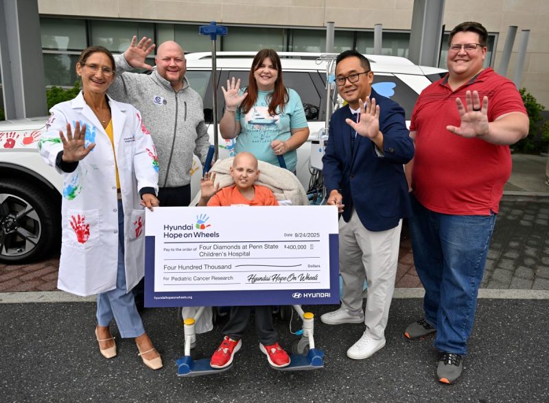 Guests gather for a group photo during the Hyundai Hope on Wheels event at Penn State Health Milton S. Hershey Medical Center, Wednesday, September 24, 2025. Hyundai Hope on Wheels presented a research grant check to Dr. Giselle Sholler and had a car outside for the children in clinic to put their hand prints on with washable paint.