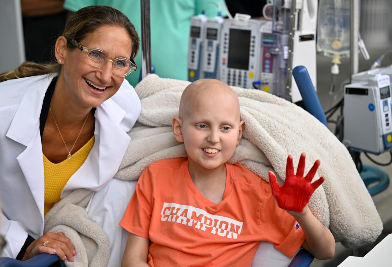Cancer patient Riley Rejniak shows off his painted hand with his oncologist, Dr. Giselle Sholler, during the Hyundai Hope on Wheels event at Penn State Health Milton S. Hershey Medical Center, Wednesday, September 24, 2025.