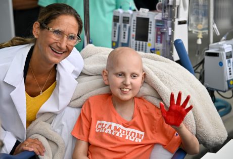 Cancer patient Riley Rejniak shows off his painted hand with his oncologist, Dr. Giselle Sholler, during the Hyundai Hope on Wheels event at Penn State Health Milton S. Hershey Medical Center, Wednesday, September 24, 2025.
