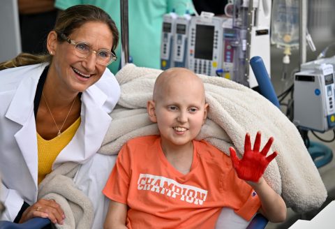 Cancer patient Riley Rejniak shows off his painted hand with his oncologist, Dr. Giselle Sholler, during the Hyundai Hope on Wheels event at Penn State Health Milton S. Hershey Medical Center, Wednesday, September 24, 2025.