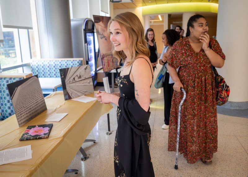 Lily Montgomery, left, joined other childhood cancer survivors as they get a first look at the Photovoice art exhibit on Tuesday, Sept. 30, 2025. The Penn State Health Children’s Hospital Childhood Cancer Survivorship Clinic hosted the art exhibit featuring the work of five childhood cancer survivors who participated in its inaugural the Photovoice program.