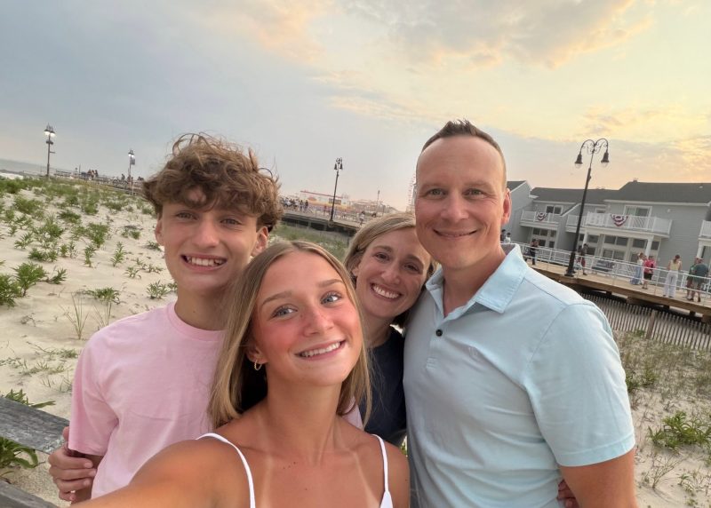 Brad smiles with his wife and two children during a family trip to the beach.