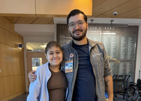 Andy smiles beside Four Diamonds interpreter Daniel at Penn State Health Golisano Children's Hospital.