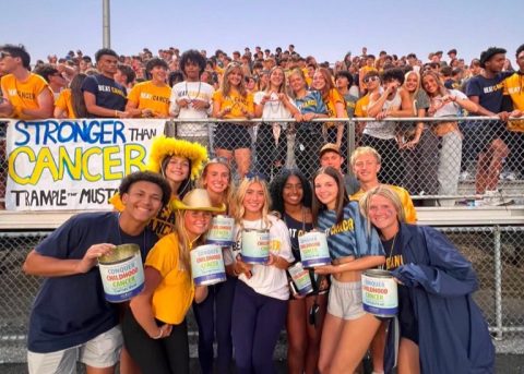 Dallastown Mini-THON students pose with Conquer Childhood Cancer fundraising cans at a school event.